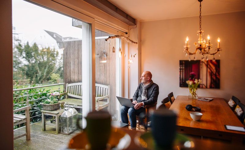 Mannelijk model van Shootz zit binnen op mooie locatie en kijkt naar buiten